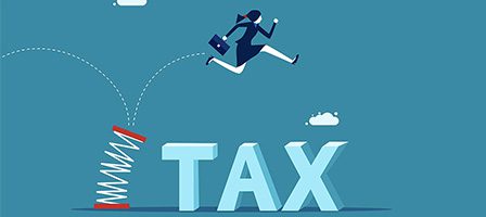 Person jumping over tax with springboard