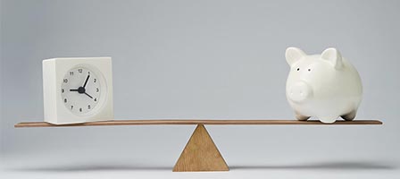 Seesaw with clock and piggy bank.