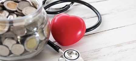 Red heart with stethoscope and coins