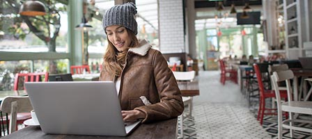 Woman in winter clothing at cafe table