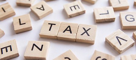 Scrabble tiles spelling "tax