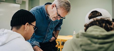 Instructor explaining to two students