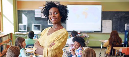 Educator smiling with students in background