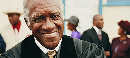 Smiling man in formal attire outdoors