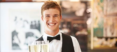 Waiter presenting sparkling wine glasses