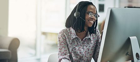Woman in floral shirt at desk