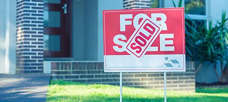 House with sold sign in front yard