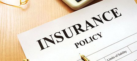 Insurance paperwork with calculator