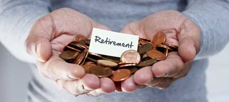 Hands holding coins and retirement note