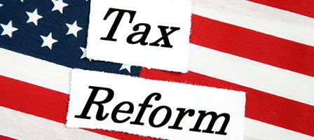 Tax reform text on American flag background