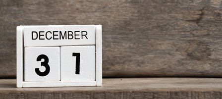 Wooden desk calendar showing December 31
