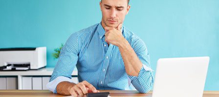 Thoughtful individual at work with devices
