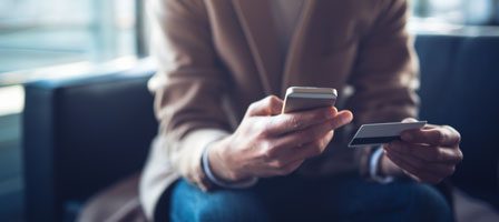 Man holding smartphone and credit card