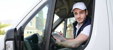 Smiling driver inside delivery vehicle