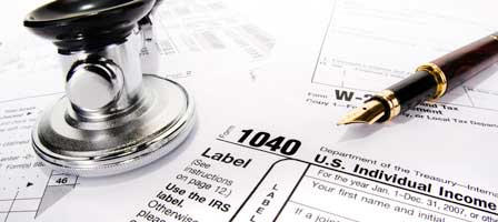 IRS 1040 form, pen, and stethoscope