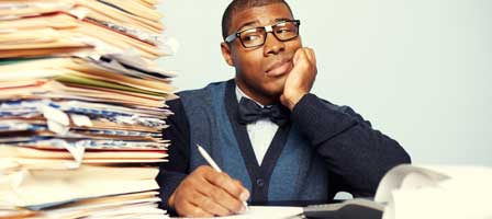 Overwhelmed office worker with paperwork stack