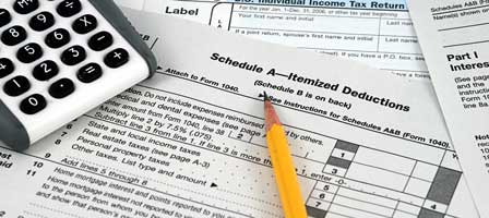 Calculator and pencil on tax forms