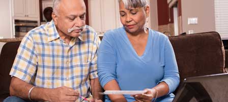 Mature couple checking financial statements