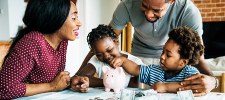 Family saving money with a piggy bank