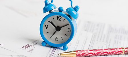 Time management with clock and paperwork