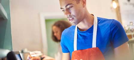 Barista working at coffee shop counter