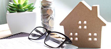 Home finances concept with house model