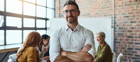 Confident businessman standing in modern office
