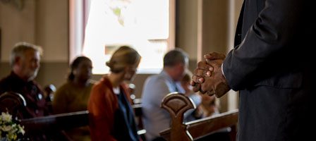 Hands clasped in prayer at church