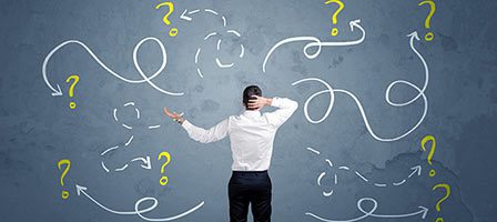 Man facing confusing arrows and question marks