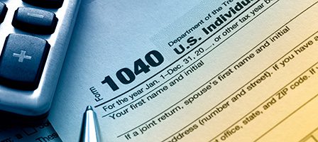 IRS Form 1040 close-up with pen