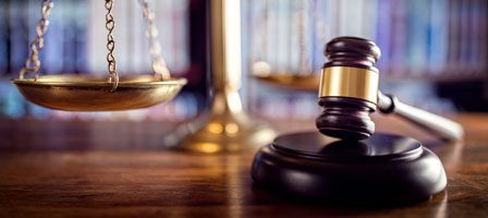 Judge's gavel beside golden scales