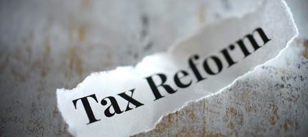 Tax reform words on ripped paper