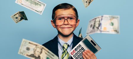 Kid in suit holding a calculator, smiling