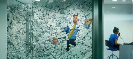 Office worker overwhelmed by paperwork