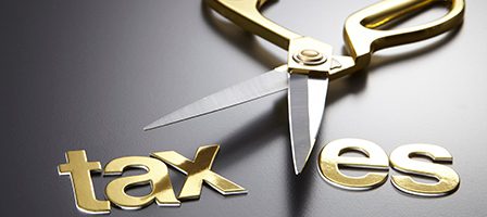 Gold scissors cutting metallic "taxes" text