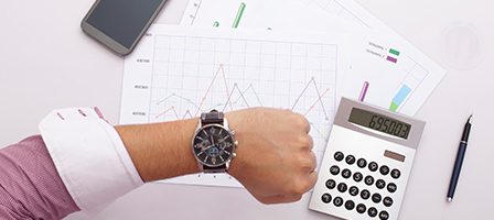 Business analysis with watch and calculator