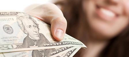 Person offering cash with a smile