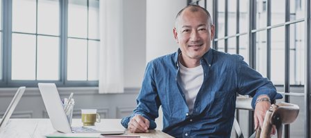 Casual businessman sitting at desk