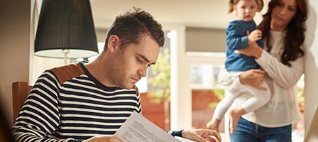 Man reading documents at home