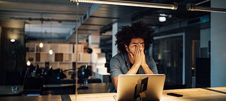 Overworked individual sitting at desk