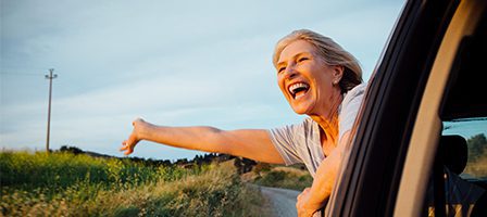 Smiling woman leaning out of car window