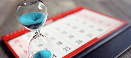 Time passing by calendar and hourglass