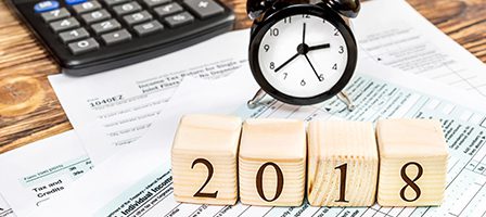 Tax documents with 2018 blocks and clock