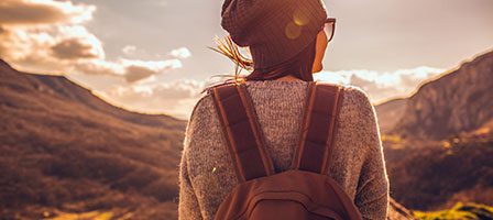 Woman hiking in scenic mountain landscape