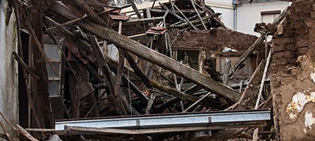 Damaged house with fallen beams