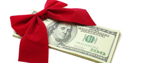 Stack of money with red bow