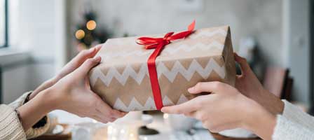 Giving a gift with red ribbon