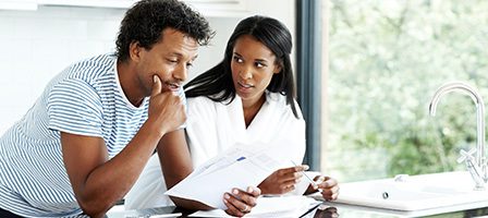 Couple reviewing documents in kitchen