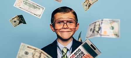 Child with calculator and flying dollar bills