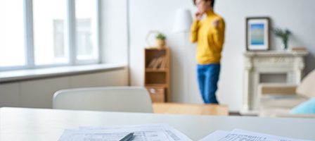 Focus on documents, person standing behind